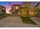 Charming home with a two-car garage, balcony, and a beautifully landscaped front yard at sunset at 10705 Pinewalk Way, Highlands Ranch, CO 80130