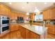 Bright kitchen featuring stainless steel appliances, hardwood floors, and a large center island at 10705 Pinewalk Way, Highlands Ranch, CO 80130