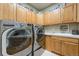 Functional laundry room equipped with washer, dryer, built-in cabinets, and a sink for convenience at 10705 Pinewalk Way, Highlands Ranch, CO 80130