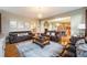 Open-concept living area with hardwood floors, comfortable seating, fireplace, and natural light at 10705 Pinewalk Way, Highlands Ranch, CO 80130