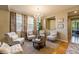 Elegant living room with ample natural light, stylish seating arrangements and decorative accents at 10705 Pinewalk Way, Highlands Ranch, CO 80130