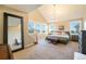 Spacious bedroom with vaulted ceilings, large windows, staircase, and a luxurious chandelier at 10705 Pinewalk Way, Highlands Ranch, CO 80130
