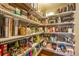 Well-organized walk-in pantry with wire shelving filled with an abundance of food and household items at 10705 Pinewalk Way, Highlands Ranch, CO 80130
