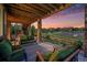 Covered patio with comfortable seating, offering a relaxing outdoor space to enjoy the surrounding landscape at 10705 Pinewalk Way, Highlands Ranch, CO 80130