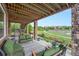 Relaxing outdoor patio with green seating, a lush lawn view, and open-air design at 10705 Pinewalk Way, Highlands Ranch, CO 80130