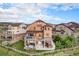 Expansive backyard with multi-level deck, patio seating and meticulously manicured lawn at 10705 Pinewalk Way, Highlands Ranch, CO 80130