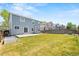 A spacious backyard featuring a green lawn, patio, and privacy fence at 9753 Gatesbury Cir, Highlands Ranch, CO 80126