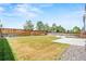 Large backyard featuring green grass, wood fence, landscaping, and concrete patio at 9753 Gatesbury Cir, Highlands Ranch, CO 80126
