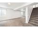 Spacious basement with staircase, neutral walls, and carpeted flooring at 9753 Gatesbury Cir, Highlands Ranch, CO 80126