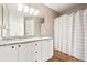 Bathroom with a double vanity sink and shower with curtain at 9753 Gatesbury Cir, Highlands Ranch, CO 80126