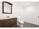 Bathroom featuring modern vanity, framed mirror, vinyl floor, and toilet, offering a clean functional design at 9753 Gatesbury Cir, Highlands Ranch, CO 80126