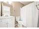 Clean bathroom with a shower/tub combo, single sink vanity and neutral finishes at 9753 Gatesbury Cir, Highlands Ranch, CO 80126
