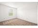 Simple carpeted bedroom with window at 9753 Gatesbury Cir, Highlands Ranch, CO 80126