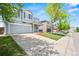 Exterior view of a two-story house, with a two-car garage, small porch, and well-kept lawn at 9753 Gatesbury Cir, Highlands Ranch, CO 80126