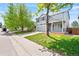 Two-story house featuring a lush green lawn, mature trees, and a concrete driveway at 9753 Gatesbury Cir, Highlands Ranch, CO 80126