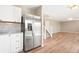 Kitchen area featuring stainless steel refrigerator, granite countertops, and hardwood flooring at 9753 Gatesbury Cir, Highlands Ranch, CO 80126