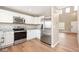 Well-equipped kitchen with stainless steel appliances, granite countertops, and white cabinets at 9753 Gatesbury Cir, Highlands Ranch, CO 80126