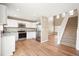Modern kitchen with stainless appliances, granite countertops, and adjacent staircase at 9753 Gatesbury Cir, Highlands Ranch, CO 80126