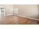 Spacious living room with ample natural light, neutral walls and stylish hardwood floors at 9753 Gatesbury Cir, Highlands Ranch, CO 80126
