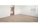 Spacious primary bedroom with carpeted floors and en suite bathroom at 9753 Gatesbury Cir, Highlands Ranch, CO 80126