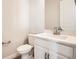 This half bathroom features a white vanity with a quartz countertop at 1807 Grayside Cir, Castle Rock, CO 80109