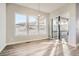 Elegant dining area featuring wood floors, modern chandelier, and mountain views from large windows at 1807 Grayside Cir, Castle Rock, CO 80109