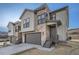 Inviting home featuring a 2-car garage, stone and siding exterior, and professional landscaping at 1807 Grayside Cir, Castle Rock, CO 80109