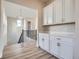 Upstairs hallway with hardwood flooring, cabinets, and railing at 1807 Grayside Cir, Castle Rock, CO 80109