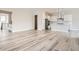 Spacious living room with wood floors, adjacent to a modern kitchen featuring stainless steel appliances at 1807 Grayside Cir, Castle Rock, CO 80109