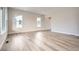 Bright, open living room with wood flooring, neutral paint, and abundant natural light at 1807 Grayside Cir, Castle Rock, CO 80109