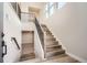 Modern staircase with wood treads, black iron railing, and an open design that creates a grand entry at 1807 Grayside Cir, Castle Rock, CO 80109