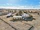 Aerial view shows home, detached buildings, and surrounding landscape at 9042 E Wagon Wheel Way, Parker, CO 80138