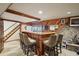 Basement bar with four stools and wood finishes at 9042 E Wagon Wheel Way, Parker, CO 80138