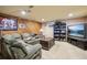 Finished basement with sectional sofa and entertainment center at 9042 E Wagon Wheel Way, Parker, CO 80138