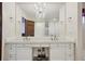 Elegant bathroom with double vanity, chandelier, and large mirror at 9042 E Wagon Wheel Way, Parker, CO 80138