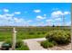 A spacious backyard with lush greenery and a view of a distant field under a partly cloudy sky at 17548 Bluetrail Ave, Parker, CO 80134