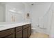 Bathroom with vanity, toilet, white shower curtain, and large mirror at 17548 Bluetrail Ave, Parker, CO 80134