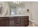 Bathroom features a vanity with dark cabinets, white countertops, a large mirror, and a combined shower and tub at 17548 Bluetrail Ave, Parker, CO 80134