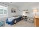 Fun bedroom with race car bed, a light gray chair, and a white bookcase at 17548 Bluetrail Ave, Parker, CO 80134