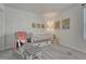 Inviting Bedroom with a white crib, rocking chair, soft carpet, and playful decorative artwork at 17548 Bluetrail Ave, Parker, CO 80134