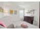 Bedroom with white crib and changing table with floral artwork and lamps at 17548 Bluetrail Ave, Parker, CO 80134
