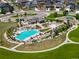 Aerial view of the community pool and clubhouse area with lounge seating, landscaping, and walking paths at 17548 Bluetrail Ave, Parker, CO 80134