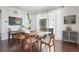 Dining room with modern wood table, chairs, hardwood flooring and sliding glass doors to an outdoor space at 17548 Bluetrail Ave, Parker, CO 80134