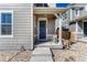 Inviting entryway with a dark blue front door adorned with a wreath, offering a warm welcome to visitors at 17548 Bluetrail Ave, Parker, CO 80134