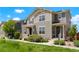 A well-maintained townhome with green lawn and landscaping on a sunny day, showcasing its inviting facade at 17548 Bluetrail Ave, Parker, CO 80134