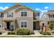 Charming townhome featuring a well-manicured lawn and neutral-toned exterior under a bright, partly cloudy sky at 17548 Bluetrail Ave, Parker, CO 80134
