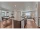 Bright and airy kitchen with a large island, modern appliances, and an adjacent dining area with sliding glass doors at 17548 Bluetrail Ave, Parker, CO 80134