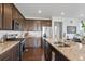 Well-equipped kitchen with stainless steel appliances, granite countertops, and dark wood cabinets; modern and functional at 17548 Bluetrail Ave, Parker, CO 80134