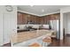 Modern kitchen features stainless steel appliances, granite counters, dark wood cabinets, and an island with seating at 17548 Bluetrail Ave, Parker, CO 80134