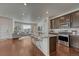 Open-concept kitchen with a breakfast bar, stainless steel appliances, and seamless flow into the living area at 17548 Bluetrail Ave, Parker, CO 80134